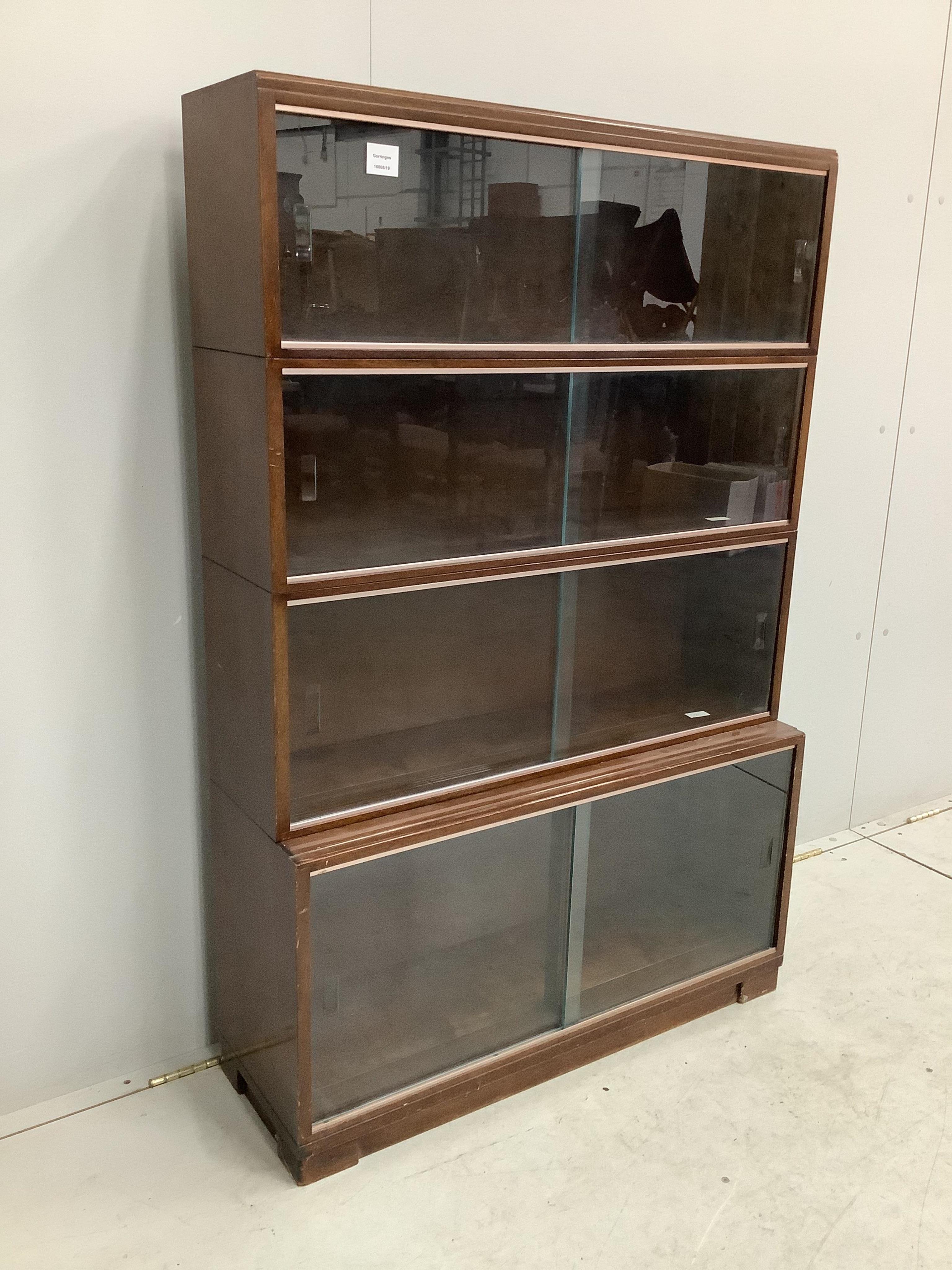 A Minty style mahogany four section bookcase, width 89cm, depth 29cm, height 135cm. Condition - fair to good